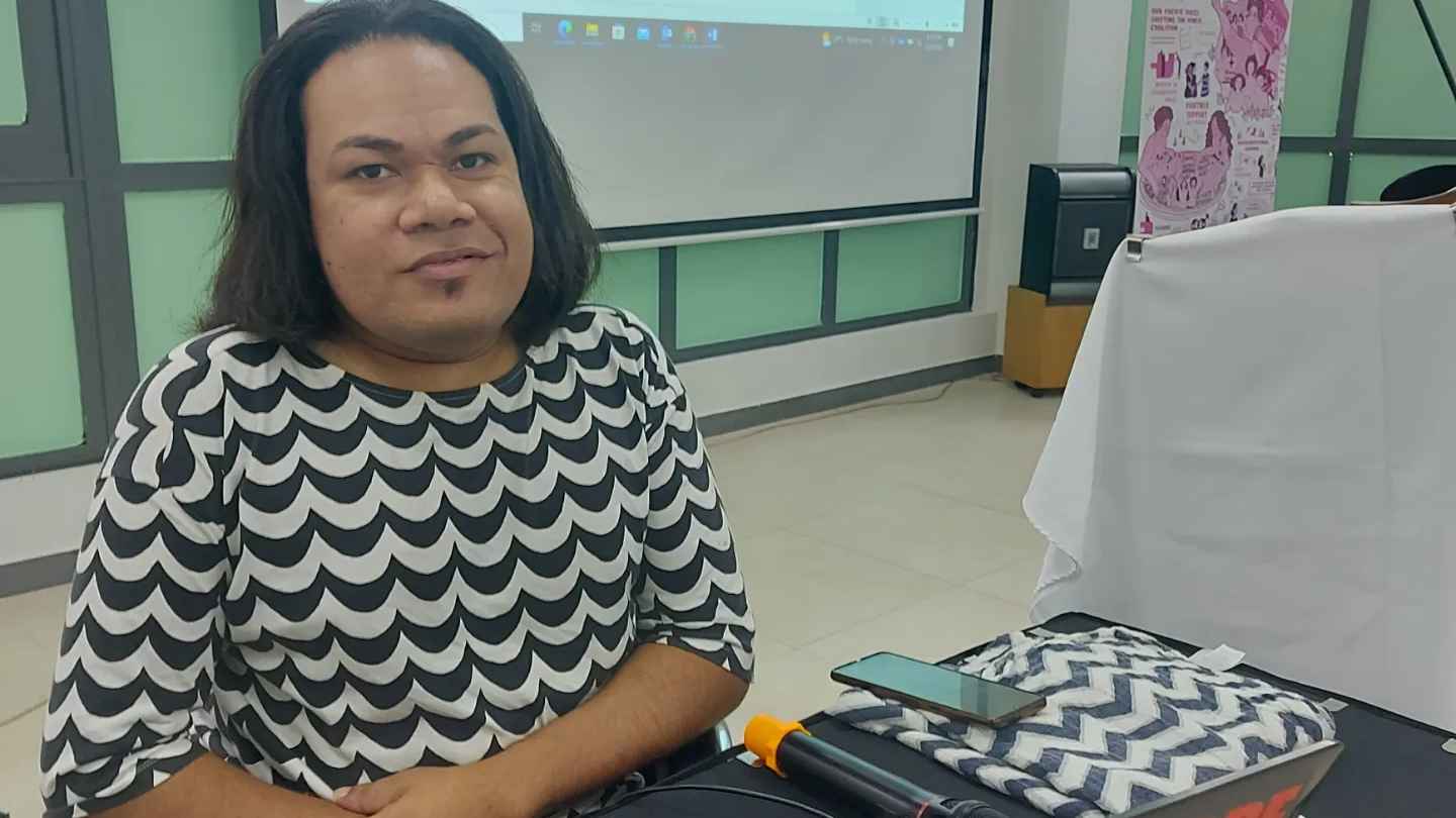Photo of Jay sitting in wheelchair looking at camera