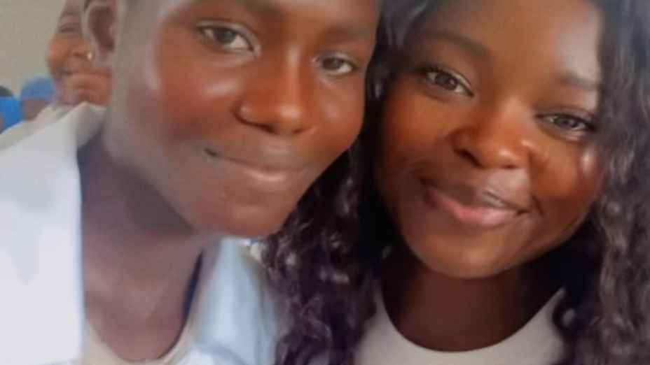 A picture of a girl and a young adult in a classroom