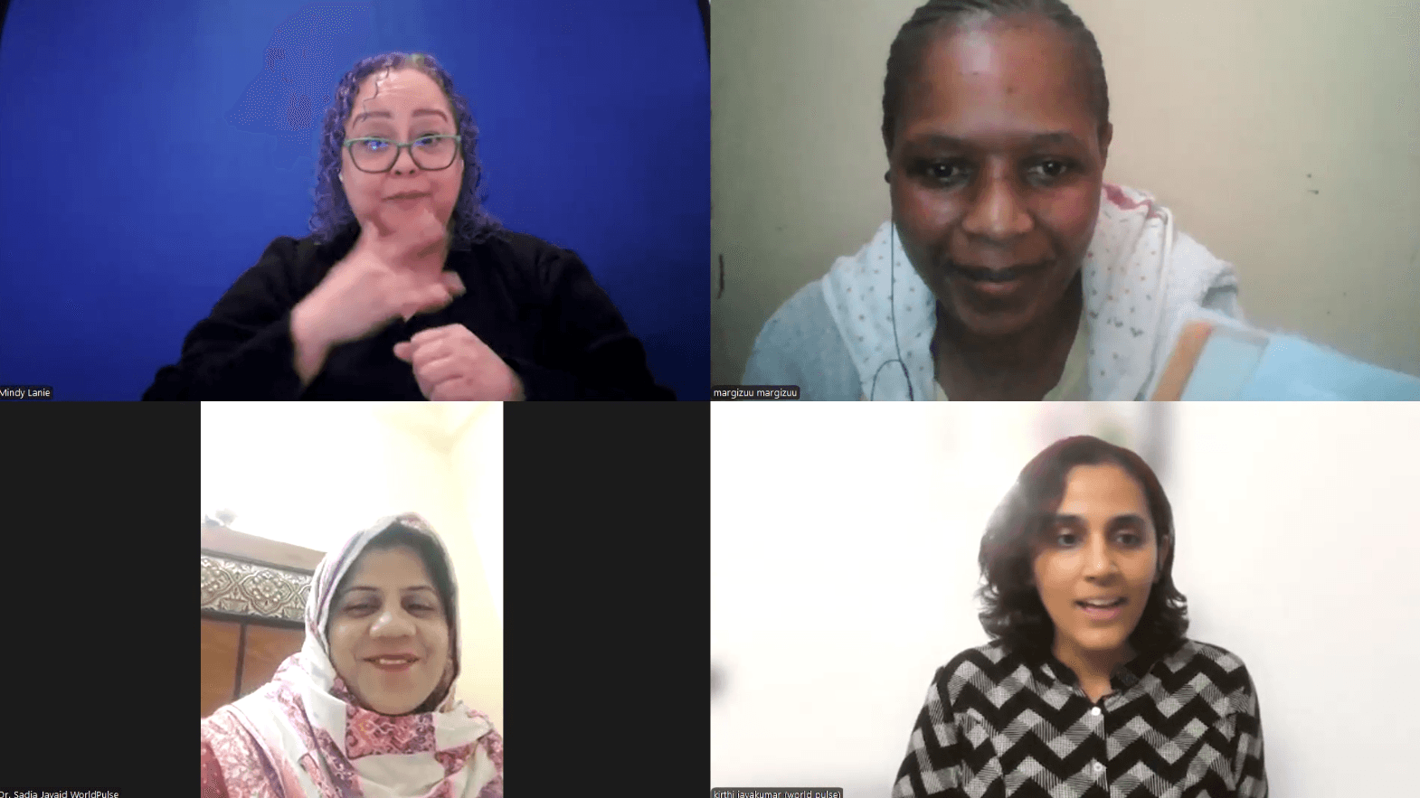 A moment from our encourager party. Four women on a Zoom call: One woman with curly, purple hair working as our ASL interpreter, a woman named Margizu wearing a white shirt against a yellow wall,